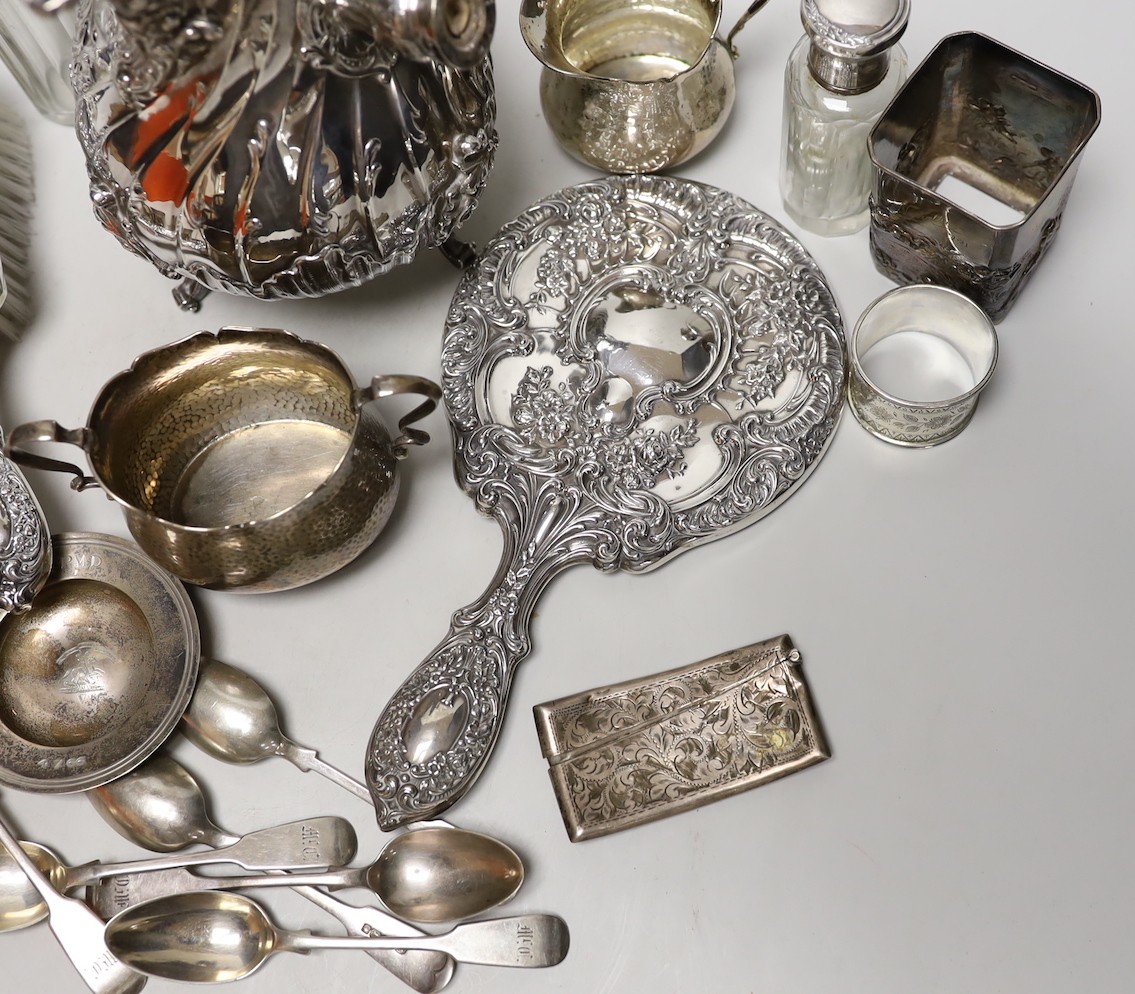 A late 19th/early 20th century French white metal coffee or chocolate pot (lacking handle), gross 21.5oz, a silver cream jug and sugar bowl, five French white metal mounted toilet jars, three silver napkin rings, a silve